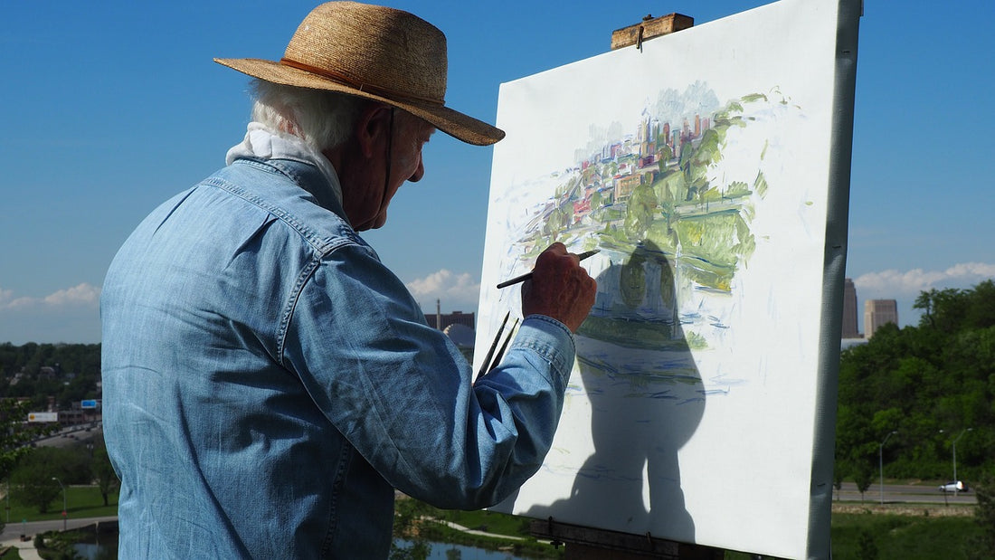 Adult painting outdoors with paint