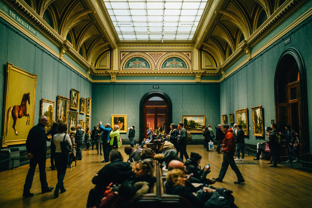 people walking in hallway inside art gallery
