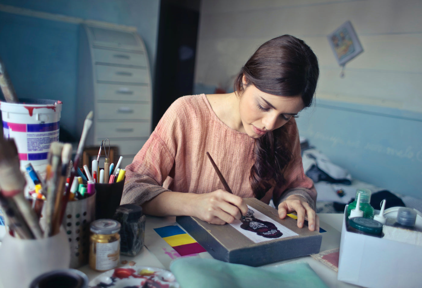 woman in brown scoop neck painting relaxing in her room