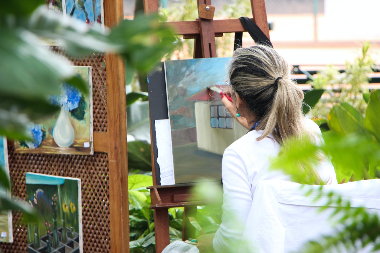 woman painting house outdoors garden